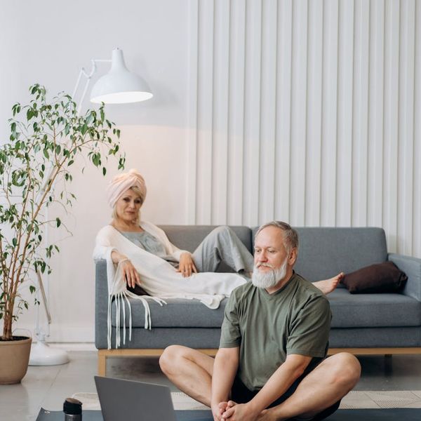Person feeling energetic and stretching in a bright living room.